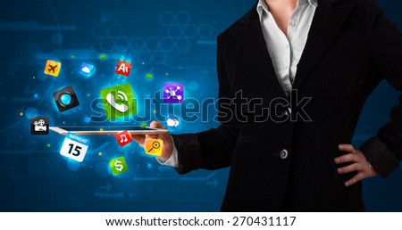 Young lady holding a tablet with modern colorful apps and icons