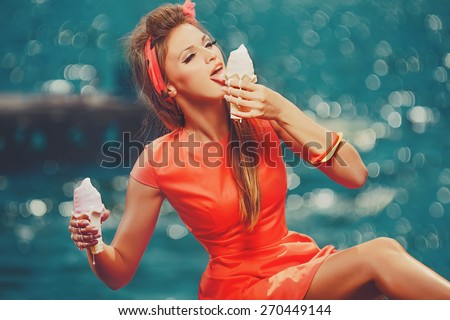 Bright picture of pretty woman eating melted  ice-cream on the beach