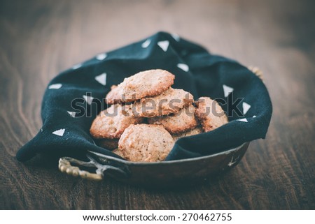 Homemade oat and nut cookies on wooden background. Toned picture