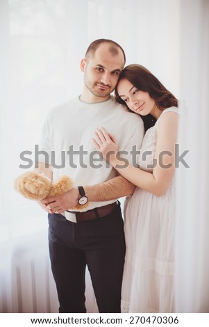 Beautiful pregnant woman and her husband is in their bedroom