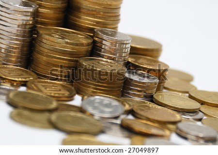 Different coins stacked on white background