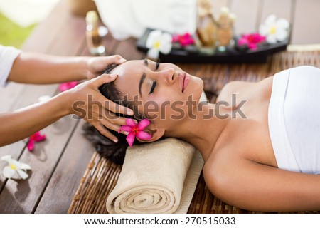 Masseur doing massage the head of an Asian woman in the spa salon Royalty-Free Stock Photo #270515033