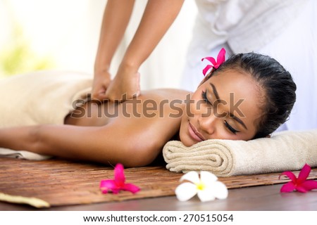 Balinese massage in spa environment,  deep massage of back  