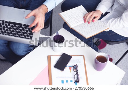 Businessman using laptop and mobile phone