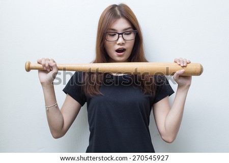 Young asian girl with baseball racket in black shirt and white background