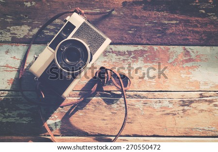 Retro camera on wooden background, vintage color tone , instagram effect filter