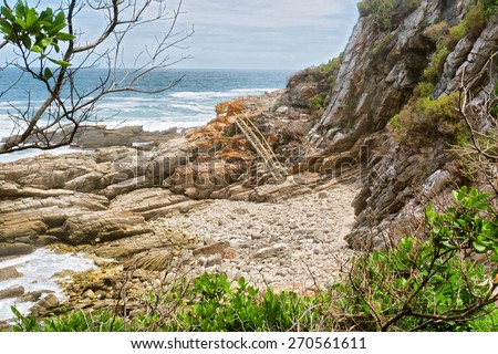 Rocky beach and ladder. Shot on the Otter trail in the Tsitsikamma National Park, Garden Route area, Western Cape, South Africa. 