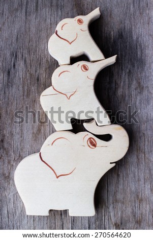 Three wooden elephants, traditional toys, symbol of happy strong family.