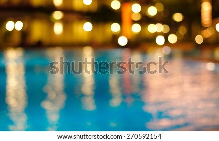 blur bokeh night light reflection in summer swimming pool Christmas party blue water abstract background Royalty-Free Stock Photo #270592154