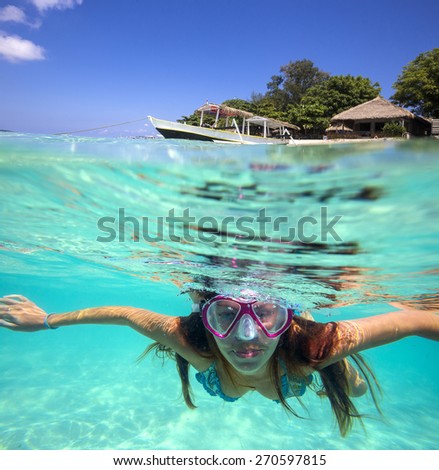 Underwater Portrait of a Yong Woman Snorkeling in Ocean.