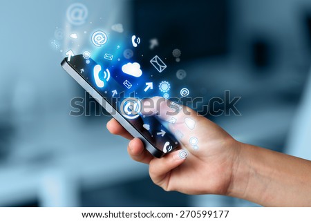 Business man holding smart phone with media icons concept on background Royalty-Free Stock Photo #270599177