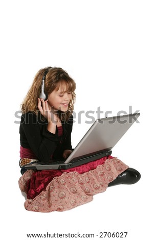 young child listening to music on laptop