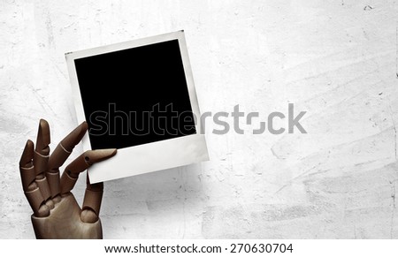 Closeup of dark wood hand with photo frame