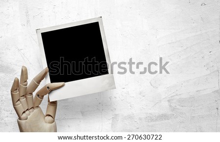Closeup of wood hand with photo frame