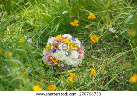 picture of a wedding bouquet , Wedding bouquet of pink and white roses lying on grass