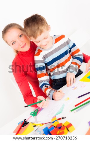 Happy mother and child drawing together