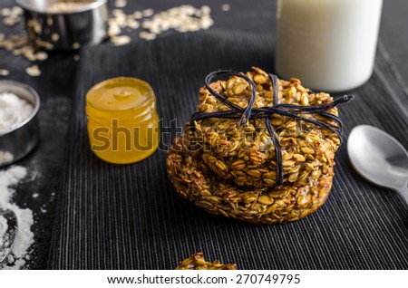 Banana cookies with flakes and honey, milk and ingredients on picture