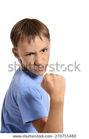 Portrait of an angry teenage boy on white background