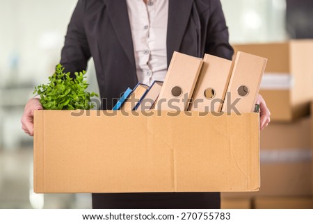 Close-up. Smiling young businesswoman holding cardboard box with her things. Royalty-Free Stock Photo #270755783