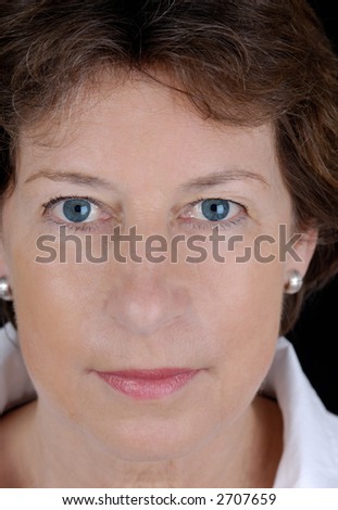 Portrait from a senior business woman. Picture was taken in a studio.
