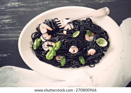 Squid ink homemade pasta with shrimp basil toned image