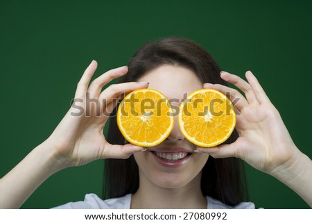 Woman holding sliced oranges