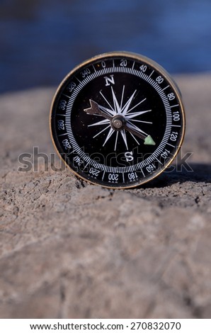Orientation Concept - Analogic Compass Abandoned on the Rocks