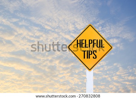 Road sign indicating Helpful Tips on blurred sky and cloud with sunlight background