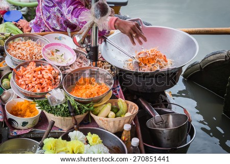 Pad Thai cooking on the boat in Amphawa floating market Royalty-Free Stock Photo #270851441
