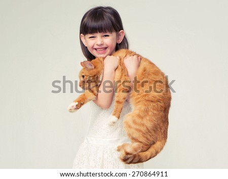 Cute little girl portrait hug red cat smiling 