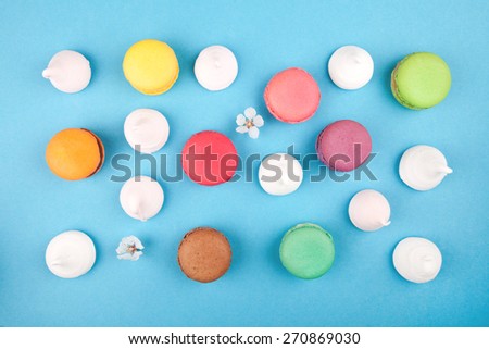 macaroon background, colorful macaroons with flower on blue background