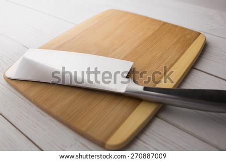 Chopping board with large knife shot in studio