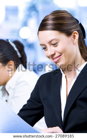 Portrait of young pretty woman getting busy in office environment