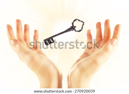 Female hands with key isolated on white