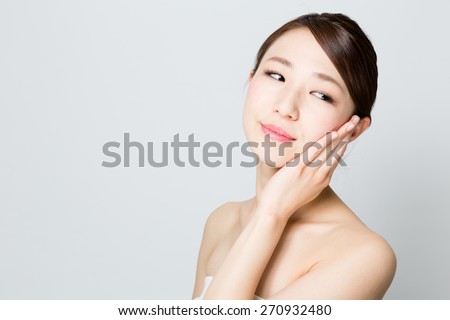 attractive asian woman skin care image on gray background 