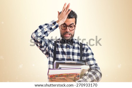 Surprised posh boy holding books