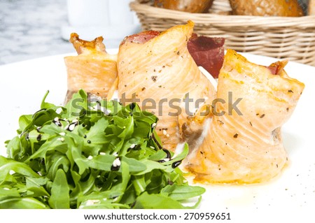 Baked fish on a white plate in a restaurant