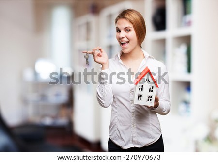 blond woman with a small house and keys