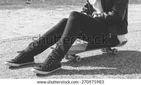 skateboarding legs at skatepark - black and white