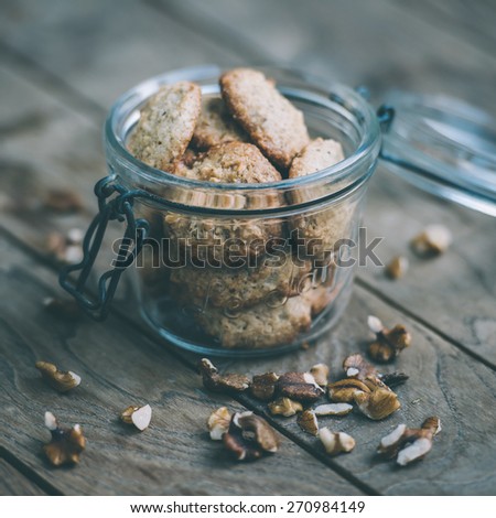 Homemade oat and nut cookies on wooden table. Toned picture