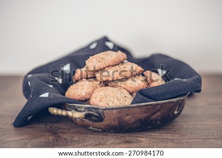 Homemade oat and nut cookies on wooden background. Toned picture