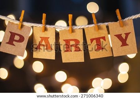 The word PARTY printed on clothespin clipped cards in front of defocused glowing lights. Royalty-Free Stock Photo #271006340