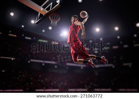 red Basketball player in action in gym Royalty-Free Stock Photo #271063772