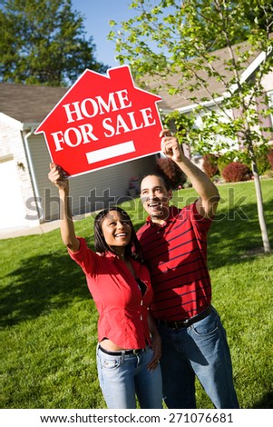 Home: Couple Holds Up For Sale Sign
