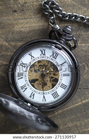 Close up of old pocket watch on rustic wooden background
