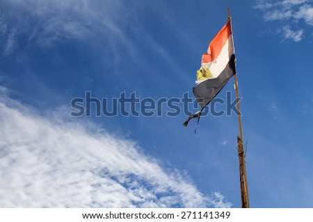 Flag in the wind, Egypt Egyptian flag in the wind. Old flag, but still expressing the national proud. Cloudy sky in the background. 
