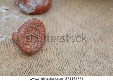 Stamp for bread with neolithic drawings.