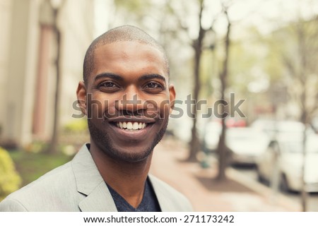 Headshot portrait of young man smiling isolated on outside outdoors background. Royalty-Free Stock Photo #271173242