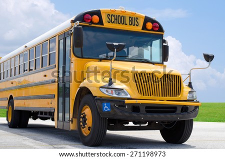 School bus on blacktop with clean sunny background Royalty-Free Stock Photo #271198973