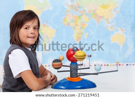 Young boy in school learning about the solar system
